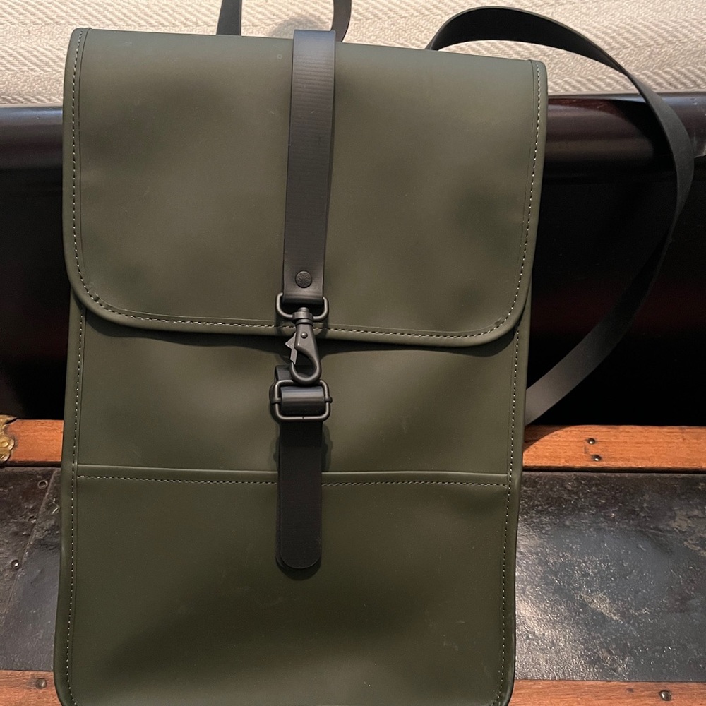 Hunter green RAIN backpack. Measures 11” X 16”.